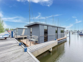 Modern house boat in Volendam with jetty